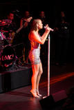 Mariah Carey performs on stage in small silver dress showing her legs and cleavage at Time Magazine 100 Most Influential People Event
